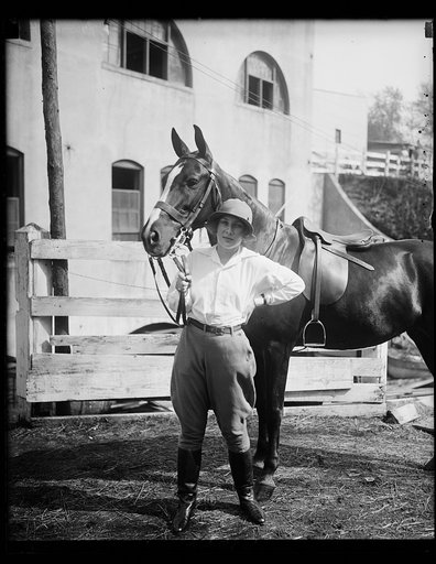 Pretty Dorothy Fell, daughter of Mrs. Ogden L. Mills, wife of the Assistant Secretary of the Treasury, and her mount "Dolly" snapped at the opening of the Washington Horse Show today. She is expected to capture a blue ribbon with this horse
