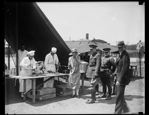 First Lady of the land tries Army chow. While inspecting the United States Army Medical exhibit in Washington today, Mrs. Calvin Coolidge, sampled a piece of meat prepared by one of the soldier cooks. The exhibit was staged for the delegates to the annual convention of the American Medical Associati