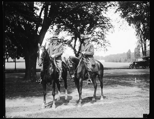 "Daddy" of Assistant Secretary of Agriculture is expert horseman at 84. Although he has passed his 84th birthday, Nelson J. Dunlap, (right) father of the Assistant Secretary of Agriculture, Renick Dunlap (left) rides horseback for his daily exercise. The elder Dunlap is a Civil War veteran and a nat