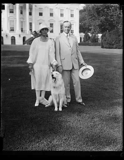 President Coolidge and Mrs. Coolidge with dog outside White House, Washington, D.C.