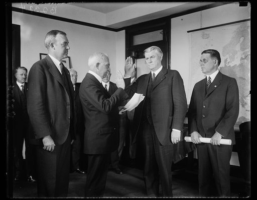 New solicitor for Department of Commerce is sworn in. Ephriam F. Morgan of Charleston, West Virginia, former Governor of the state of West Virginia, being sworn in as solicitor of the United States Department of Commerce to succeed Judge Stephen B. Davis, resigned. In the photograph, left to right: 