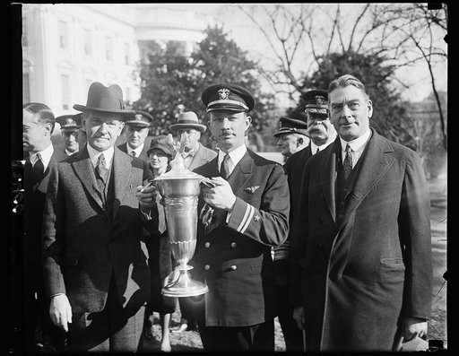 President Coolidge presents flying trophy to U.S. Navy Aviator, President Coolidge presenting the Herbert Schiff Trophy to Lieut. Arthur Gavin, United States Navy at the White House today. The trophy is awarded to naval aviator attaining the greater number in the air without accident during the fisc