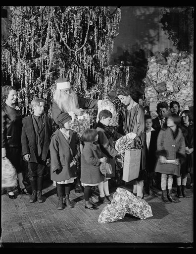 Grace Coolidge, Santa Claus, and children next to Christmas tree