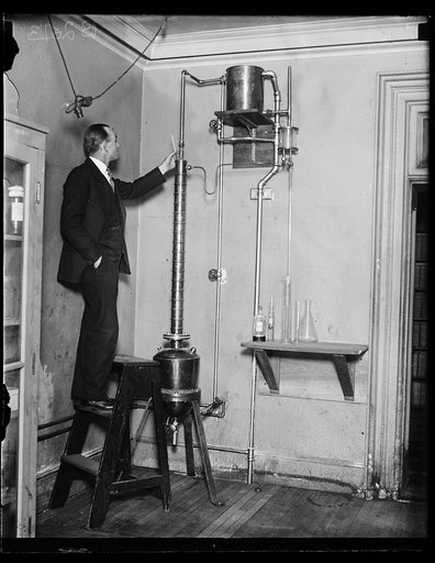 "Uncle Sam has turned distiller" in the campaign to outwit bootleggers and at the same times develop a non-poisonous denaturant for alcohol, the Prohibition Bureau has set up a modern copper still of miniature "commercial" proportions in the laboratory atop the United States Treasury building in Was
