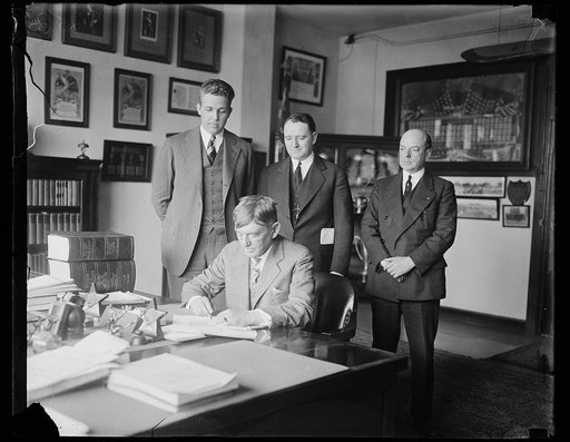 Group at table; John Archer Lejeune, seated at table