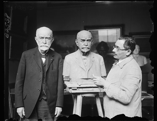 Oldest U.S. Navy officer poses for bust by noted Russian sculptor. Rear Admiral George Collier Remey, retired, and oldest living officer of the United States Navy, having his likeness sculptured by Moses Dykaar, noted Russian sculptor who has made busts of many famous Americans. Admiral Remey is 87 