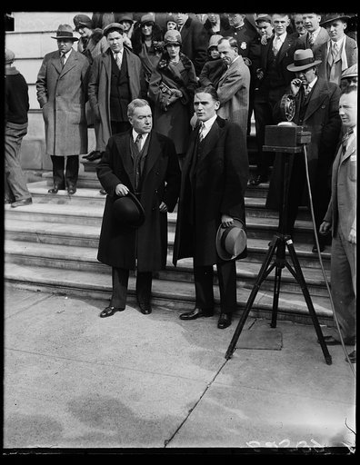 John D. Rockefeller, Jr., (left) as he left the Capitol in Washington today with Senator Nye of North Dakota, after testifying before the Senate Public Lands Committee investigating the Teapot Dome lease. Senator Nye is a member of the Senate Committee