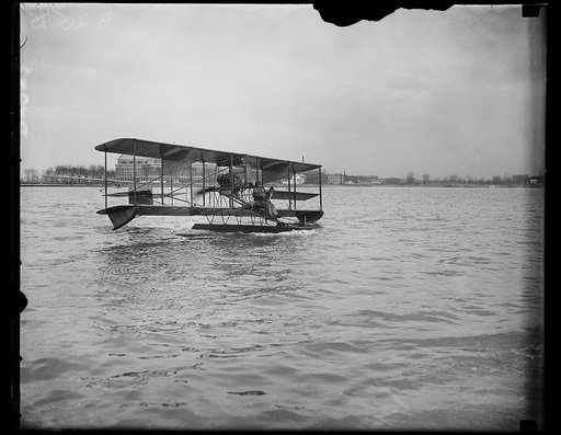 Navy flyer takes 12-year seaplane on its first flight. After lying in storage at the Washington Navy Yard more than 12 years, an obsolete 1915 model Curtiss seaplane on its maiden flight today on the [...] by Commander H.C. Richardson, crack U.S. Navy [...] who is shown at the controls in this photo