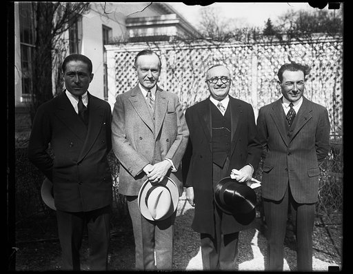 Daring French flyers are greeted by President Coolidge at the White House. Lieut. Dieudonne Costes and Lieut. Joseph Lebrix, the intrepid French flyers who were the first to fly across the South Atlantic Ocean, were presented to President Coolidge at the White House today. In the photograph, left to