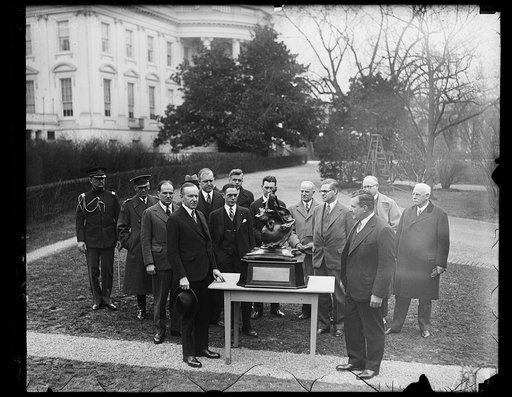 President Coolidge presents Collier Trophy to New York man for most outstanding achievement in aviation for 1927. The much coveted Collier Trophy which is awarded annually for the most outstanding achievement in aviation was presented to Charles L. Lawrence of New York by President Coolidge at the W