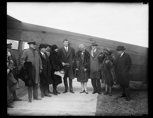 Charles Lindbergh and group next to airplane