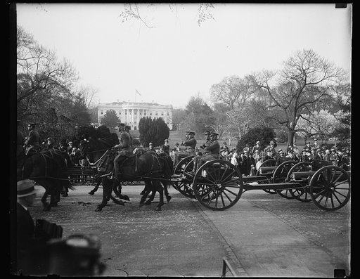 Military with horses and carts; White House in background, Washington, D.C.