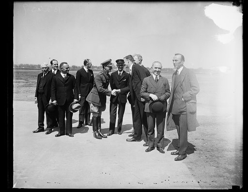 Group at field; Frank Kellogg at left, Charles Lindbergh third from right