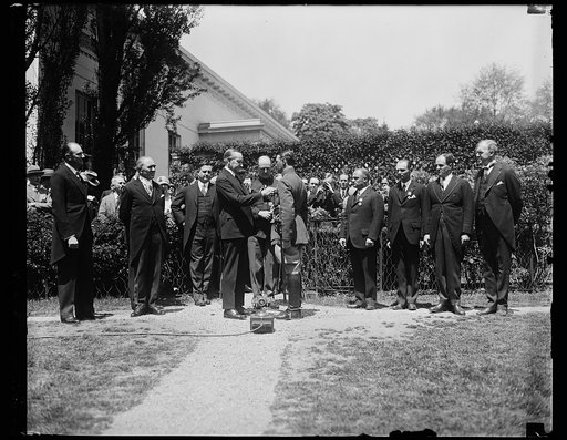 Capt. Koehl receives Medal. President Coolidge pinning the Distinguished Flying Cross on the breast of Cap. Koehl, at the White House at noon, May 2. In the group, left to right: Sanders, President Coolidge, Capt. Koehl, Baron Huenefeld, Major Fitzmaurice, Assistant Secretary of War Davison and Assi