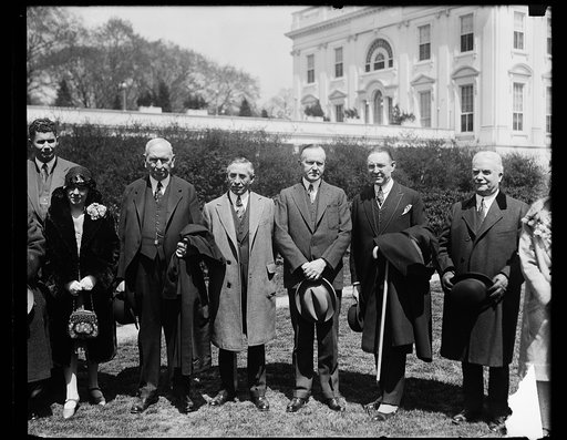 Comdr. Nicols Sansenelli, president of FIDAC and often termed the right hand man to Benito Mussolini of Italy, was received by President Coolidge at the White House today. In the group, left to right: Dr. Furico Bartorio of Rome; Col. John Thomas Taylor; Col. John M. Kenyen; Baron de Martino, Italia