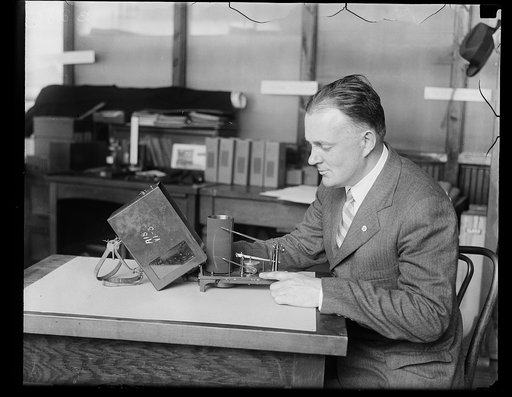 Man with device "aircraft barograph"