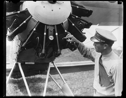 Man examining airplane propeller