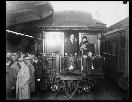 Herbert Hoover and Lou Hoover on back of train