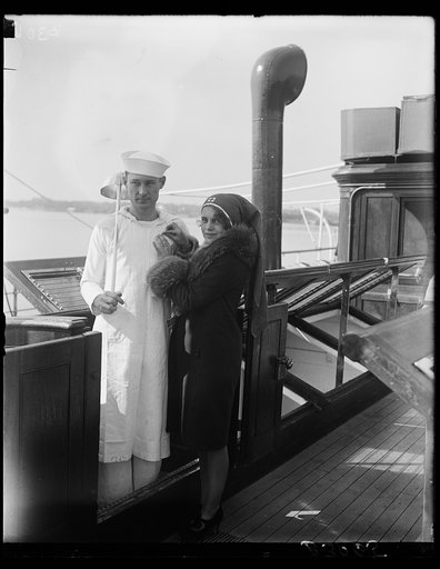 Pretty Washington debutante enrolls cook of Presidental Yacht Mayflower in Red Cross. A group of Washington debutantes took charge of the Presidential Yacht Mayflower today to enroll members of the crew in the Red Cross for 1929, Miss Ann Robbins, daughter of the Assistant Secretary of War, enrolls 
