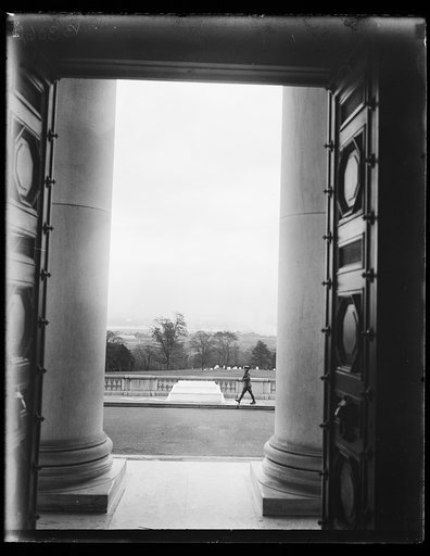A new view of the tomb of the Tomb of Americas Unknown Soldier at Arlington, VA. A striking view of the Tomb of the Unknown Soldier at Arlington National Cemetery, Va. showing the guard passing with the city of Washington in the distance