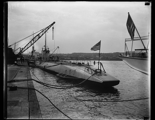 Uncle Sam's largest submarine arrives at Washington Navy Yard. The fleet submarine V-4, largest, latest and only mine-laying submarine of the United States Navy, as she appeared after docking at the Navy Yard in the National Capital today. Lieut. Comd. W.M. Quigley is in command of this submarine