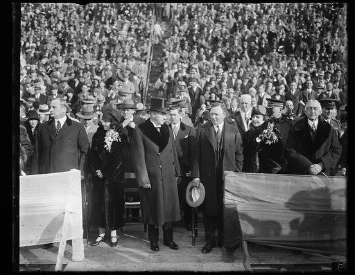 Calvin Coolidge; large crowd in stands in background