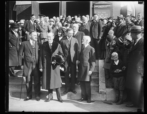 President and Mrs. Coolidge attend Thanksgiving Day service In Virginia. In Virginia for an old-fashioned Thanksgiving, President and Mrs. Coolidge attended Thanksgiving Day services at the First Baptist Church in Charlottesville, Virginia. In the photograph, left to right: Governor Angus McLean of 
