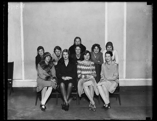 "Jockeys in the Junior League society circus." Standing, left to right, Miss Phoebe Quinby and Princess Elizabeth De Ligne, Mrs. Robert Pell, Mrs. Chauncey Parker, Jr., Miss Catherine Carlisle and Miss Jeanette Hume. Seated left to right: Princess Antoinette de Ligne, Miss Victoria Tytus, Miss Alice