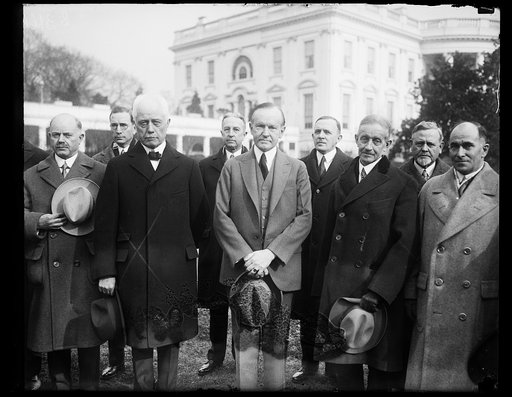 The superintendent of Uncle Sam's many lighthouses were received by President Coolidge at the White House today. In the center of the photograph, left to right: Secretary of Commerce Whiting; President Coolidge; and George R. Putnam, Commissioner of Lighthouses