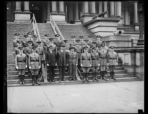 The Secretary of War, The Hon. Dwight Davis, and the Chief of Staff, the Deputy Chief of Staff, the assistants Chief of Staff, and the Chiefs of branches posed for a photograph on the steps of the war Dept. In the group left to right, front row, Major Gen. Frank Parker, Major Gen. Charles P. Summera