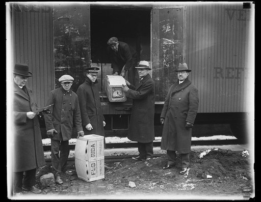 Secretary of Agriculture, William M. Jardine, (center) and representatives of Washington charitable organization, with the carload of grapefruit which was sent to Washington today by the Florida Citrus Groves Clearing House Association for distribution to hospitals, prisons, and the poor
