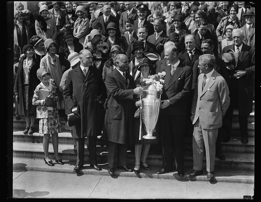 Charles Curtis holding trophy with group