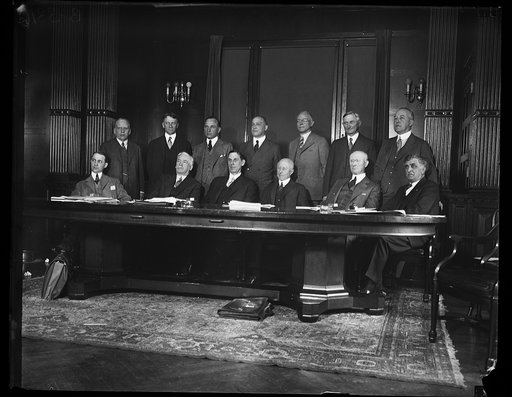 Group; includes, in front row, Ray Wilbur, third from left, and Charles Adams, foruth from left