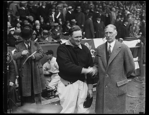 The new and the old. Connie Mac, veteran manager of the Philadelphia Athletics, greets Walter Johnson before the start of the first game in Washington today