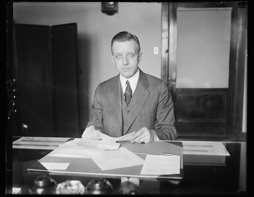 New member of Federal Radio Commission. William D.L. Starbuck, recently appointed a member of the Federal Radio Commission, photographed at his desk in Washington today. Mr. Starbuck comes from New York
