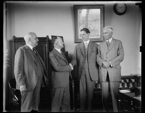 New U.S. Commissioner of Pensions assumes post at Interior Department. The new Commissioner of Pensions of the Department of Interior, Earl D. Church of Hartford, Conn. received a hearty greeting from Secretary of the Interior Ray Lyman Wilbur, as he assumed his new post today. In the photograph, le