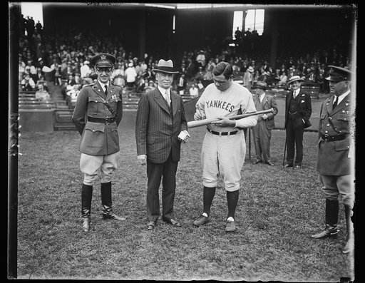 Secretary of War receives autographed balls and bats from Babe Ruth for citizens military training camps. Babe Ruth started on his annual job today at the Washington Ball Park--shot of autographing hundreds of balls and bats to be awarded as prizes at the Citizens Military Camps all over the country