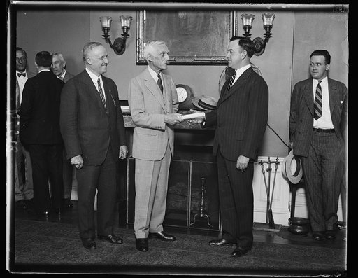 New Commissioner of Internal Revenue receiving commission from Secretary Mellon. Robert H. Lucas of Louisville, Kentucky, receiving his commission as new Commissioner of Internal Revenue from Secretary of the Treasury Andrew M. Mellon today. David H. Blair, retiring Commissioner, is shown on left