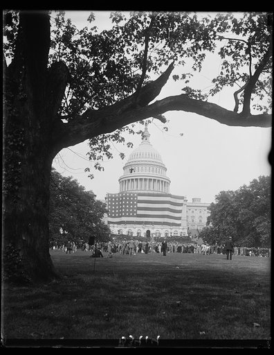 Largest Old Glory placed on U.S. Capitol for flag exercises. An unusual view of the largest American flag in the world as it was displayed across the front of the United States Capitol where flag exercises were conducted by the United States Flag Association. The flag is 160 feet in length and 90 fe