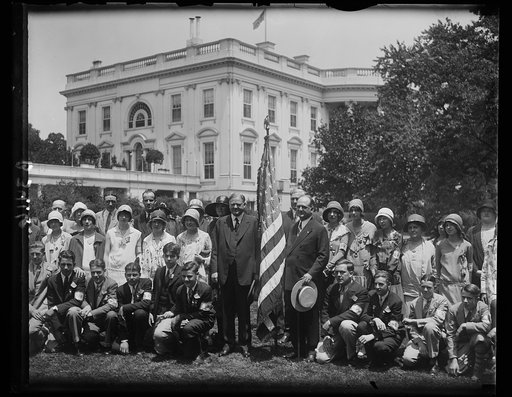 President Hoover receives flag champions. The eighteen boys and 18 girls, regional winners in the flag essay contest conducted by the United States Flag Association, were received by President Hoover at the White House today. In the center of the group, left to right: Merle Clark, Michigan; Presiden