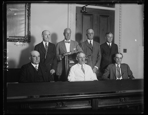 Reparations Committee confer with Secretary of State Stimson. Members of the American Reparations Commission, who recently returned to this country after negotiating a settlement with the European nations, were in conference with the Secretary of State Henry L. Stimson today. In the front row, seate