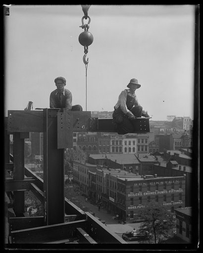 Workers on top of building under construction