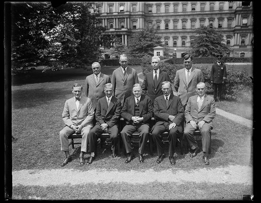 Herbert Hoover and group; State, War, and Navy building in background, Washington, D.C.