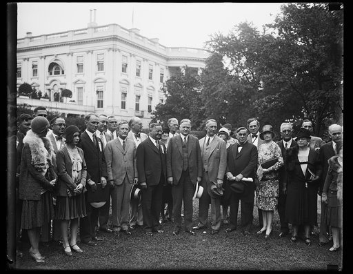 Houston Delegation received by president. A delegation from Houston, Texas, who are on their way to Norfolk, VA., for the launching of the new cruiser Houston, were received by President Hoover at the White House today. In the center of the group, left to right: Judge W.O. Huggins, representing Gov.