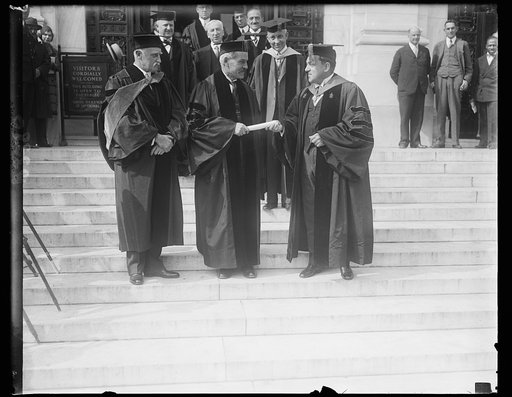 Great Britain's Prime Minister receives degree from George Washington University. Ramsey MacDonald, Prime Minister of Great Britain, receiving an honorary degree of Doctor of Laws from President Cloyd Hock Martin (right) of George Washington University in the National Capital. The British Ambassador