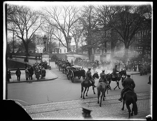 Good's funeral marked by high honors. An impressive state funeral for the late Secretary of War, James William Good, were held in the White House today. This picture taken at the White House gate shows the casket being driven into the ground on an artillery caisson, escorted by troops from all units