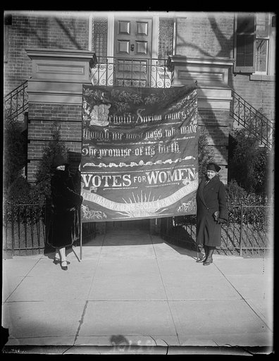 The militant flag carried by Emmaline Pankhurst in pre-war demonstration in London arrives in Washington. In Washington to attend memorial services to her mother the late Emmaline Pankhurst, noted English suffrage leader, , Miss Christable Pankhurst brought with her the famous militant flag carried 