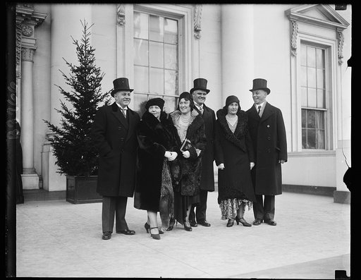 Executive Secretary Group. Secretaries to the president and their wives at the White House New Years Reception. In the group on the White House steps, left to right, are: Mr. Lawrence Richey, Mrs. Richey, Mrs. George Akerson, Mr. Akerson, Mrs. Newton and Mr. Newton