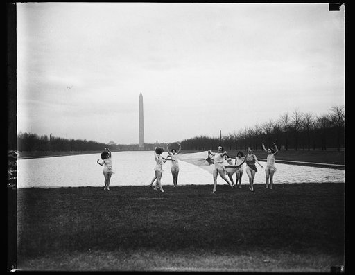 Spring-like weather brings out dancers. With the thermometer registering 70 degrees, Washington experienced the hottest January 9 in 57 years bringing forth this unusual sight of the Stafford Pemberton dancers gamboling on the green before the Lincoln Memorial reflecting pool with the Washington mon