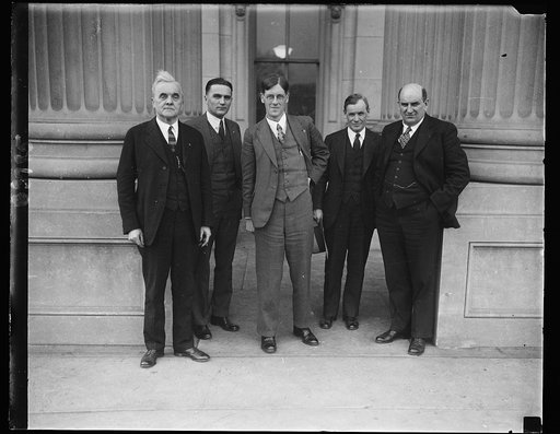 From House of Commons. Hon. [...] Brockway, member of the British House of Commons, and until his election, political Secretary of the Independent Labor Party, was a visitor at the Capitol where he was greeted by Farmer-labor Senators. In this group, left to right: Senator George W. Morris of Nebras